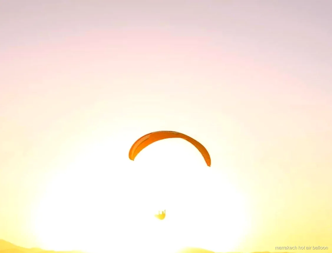 Tandem paragliding flight over the Atlas Mountains at sunset